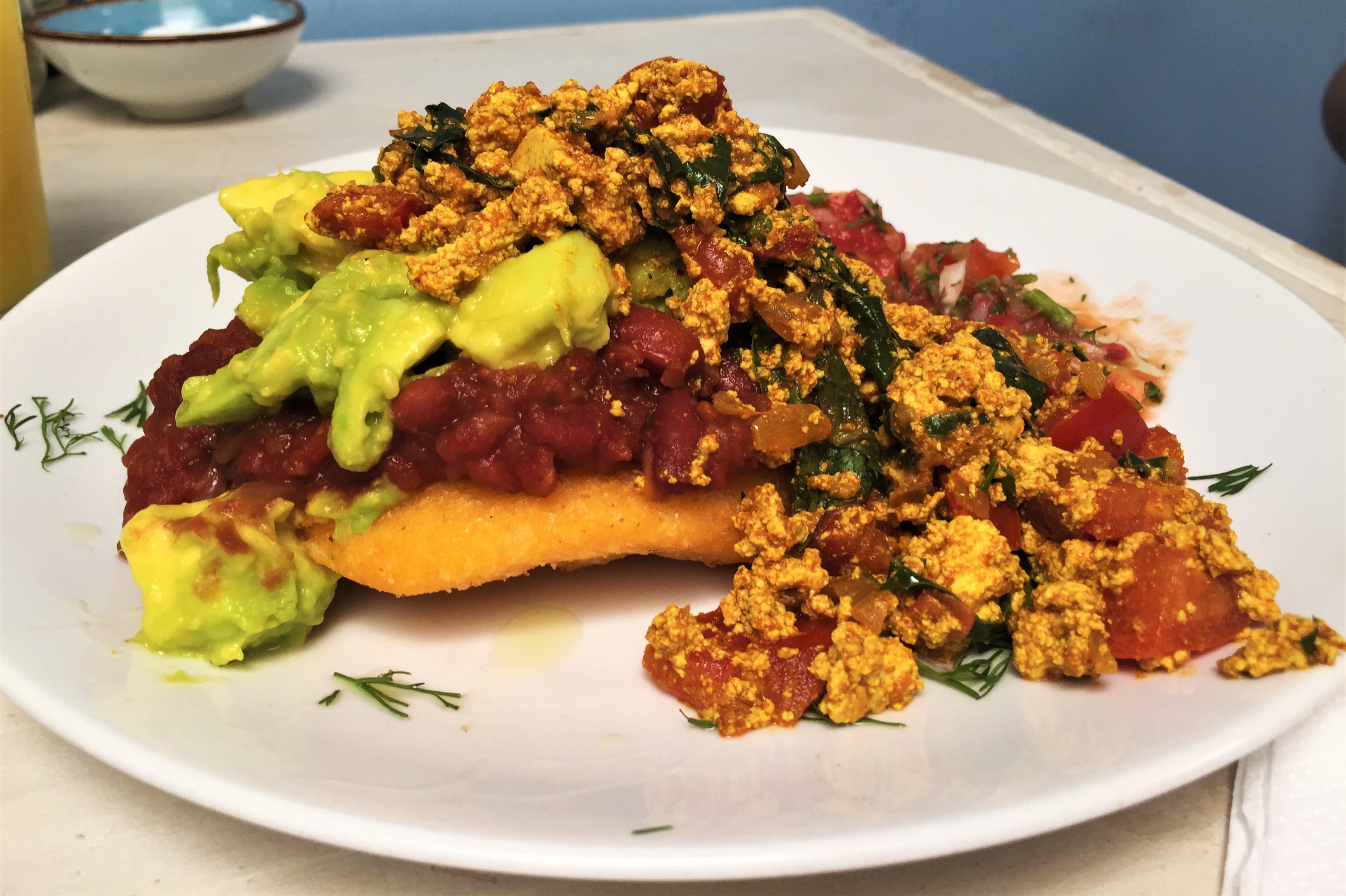 Colombian arepa with tofu scramble and avocado